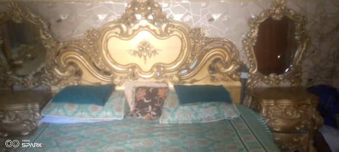 Bed and side table and showcase with mirror