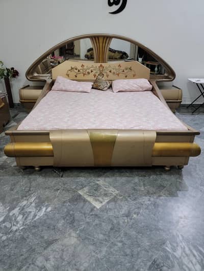 king bed with side tables and dressing table and a stool