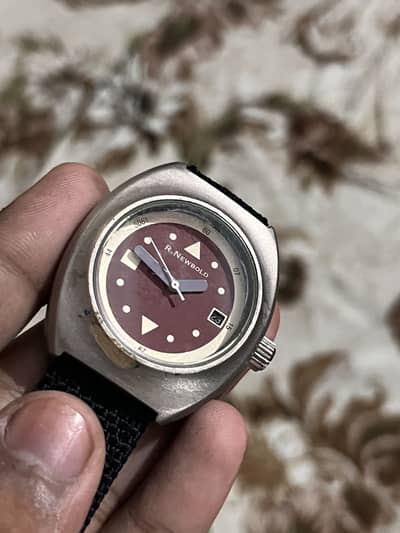 R. NEWBOLD , cushion-case military-style watch is 805-801-560