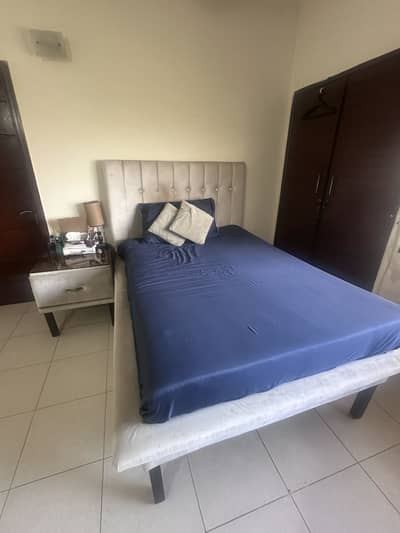 Wooden bed with side table and mirror