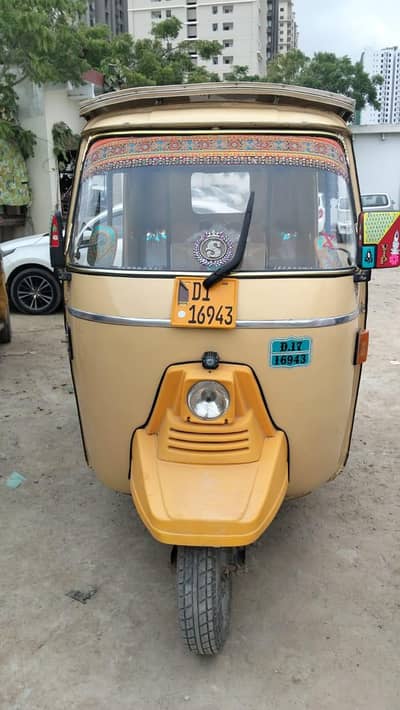 rickshaw parked outdoors with a yellow license plate reading "D1 16943