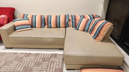 L Shaped sofa in leatherite. 8 feet long