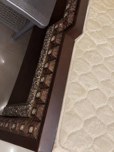 bed with spring mattress and mirror