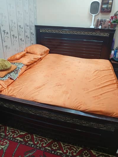 Wooden bed with mattress