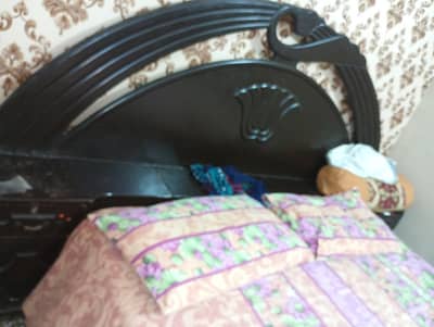 wooden bed without mattress with two side tables