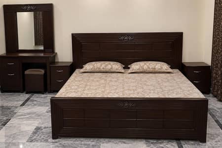 slightly used wooden bed set dressing