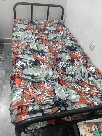 two iron single beds with mattress