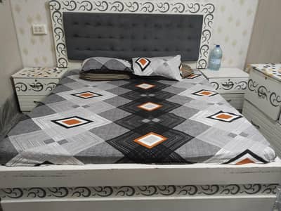 bed with side table and dressing table