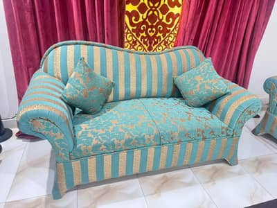 7 seater sofa available,in teal and golden colour.
