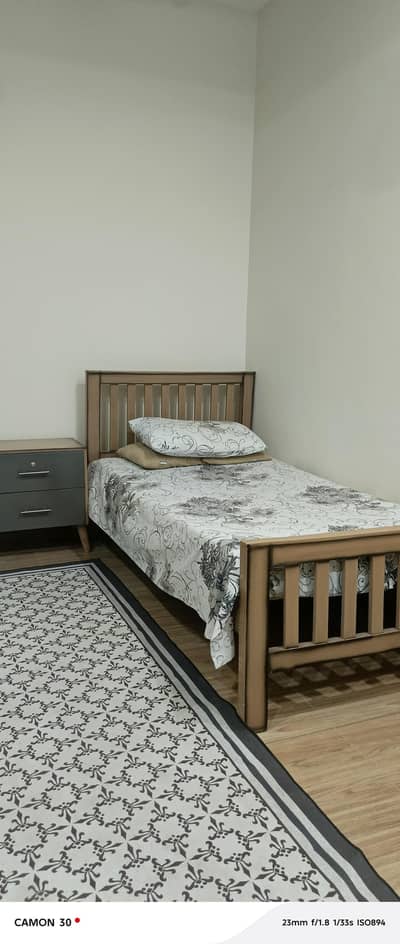 single bed with side table