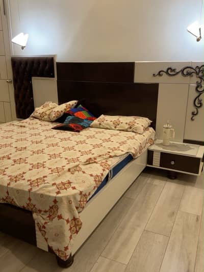 Elegant queen size bed with side tables