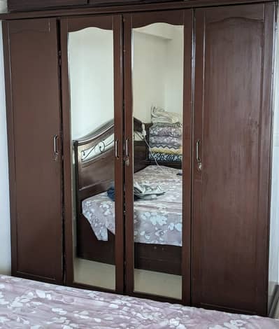 4 Door wardrobe Wooden  used brown in color