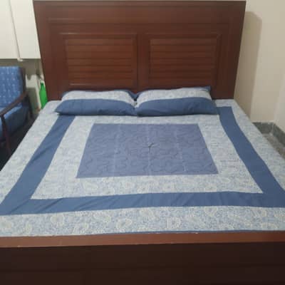 wooden bed with mattress