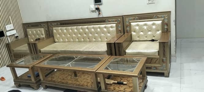 Six setter sofa set with 2 small tables and one large table.