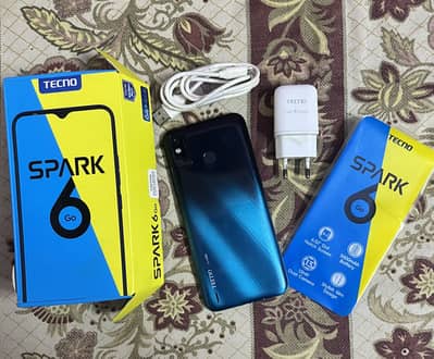 Tecno Spark 6 Go with accessories