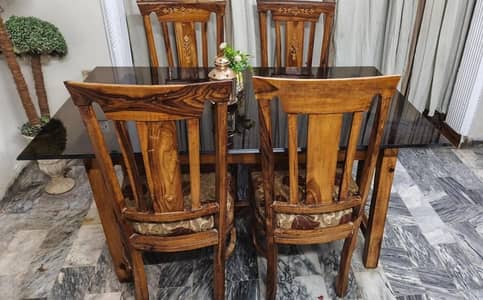 Wood dining table with heavy glass