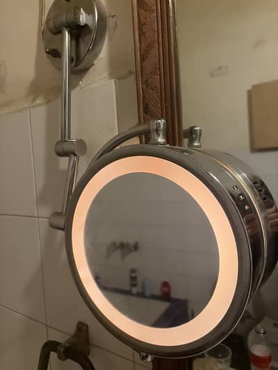 Two sided makeup mirror with light