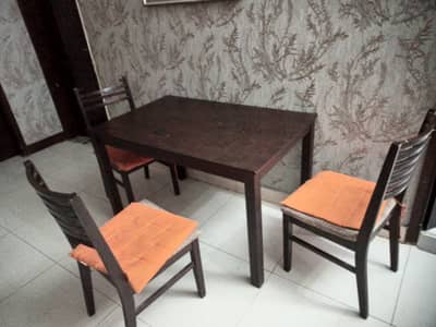 Wooden dining table with 3 chairs for sale.