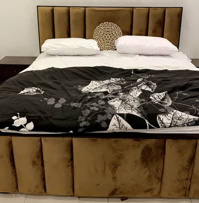 Wooden bed with velvet upholstery