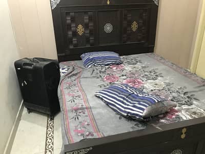 One double bed with new mattress and one side table