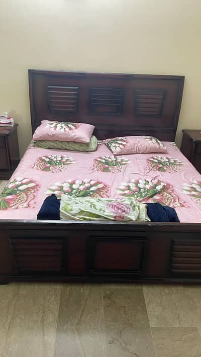 Wooden King sized bed with side tables and dressing