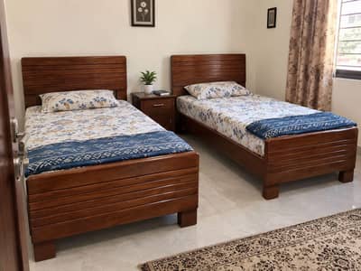 2 wooden single beds