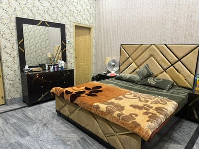wooden bed well furnished with sofa chair and coffee table