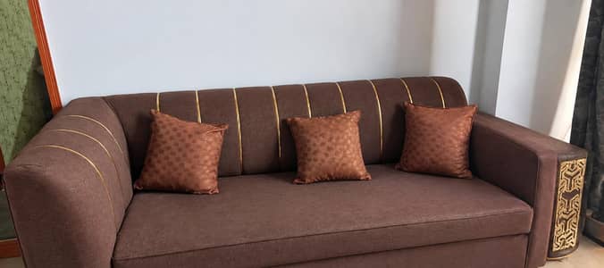 L shape sofa with cushions and wooden table