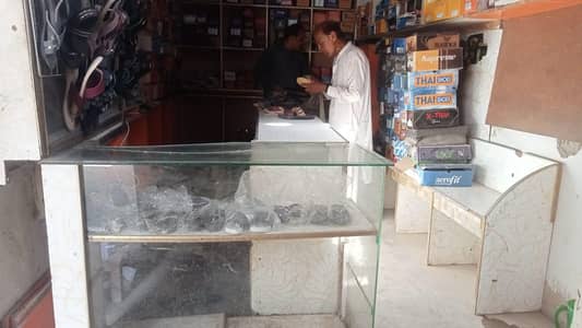 Glass counter and wooden shelves for general shop