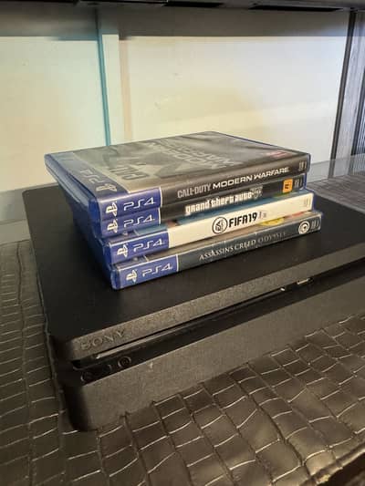 PS4 Slim 500 gb with 2 controllers and 4 games
