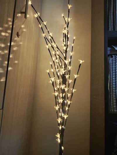 light tree and artificial flower with pot.