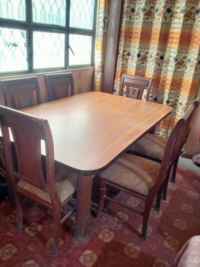 Dining table with six wooden chairs