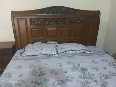 wooden bed with side tables and dressing