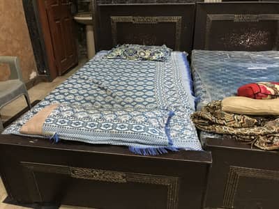 2 wooden single beds