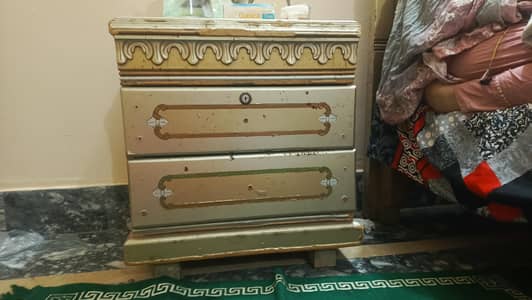 a bed with dressing table and side table and matress