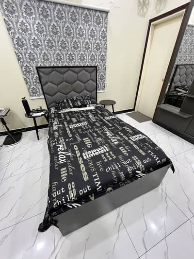 Single bed with grey cushion