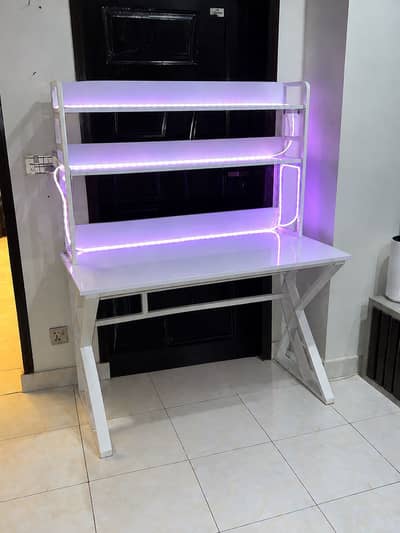 White gaming table with LED strip lights