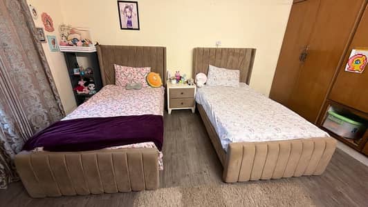 Two single beds with one side table