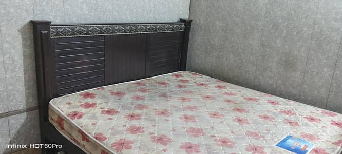 Wooden double bed with mattress