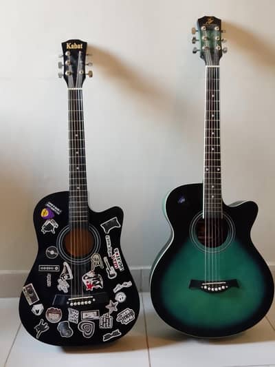 jumbo acoustic guitar with one free medium sized acoustic guitar