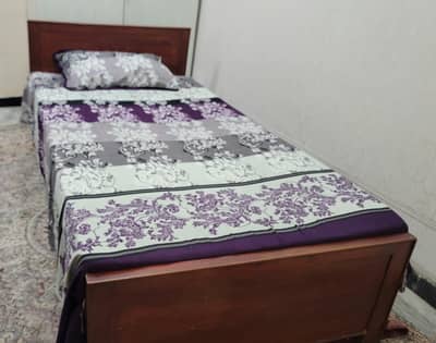 wooden single bed with mattress
