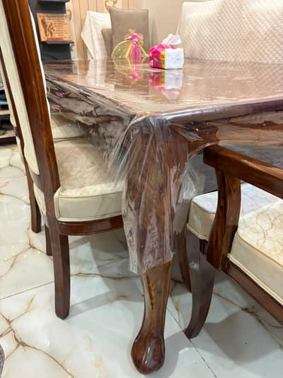 Almost new dining table with 8 chairs for sale