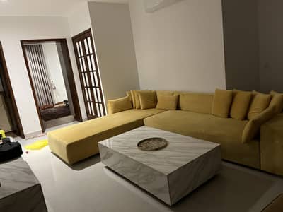 Almost new L shaped sofa with center table and console