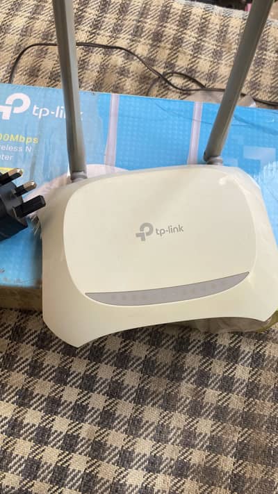 TP Link router with adapter and box