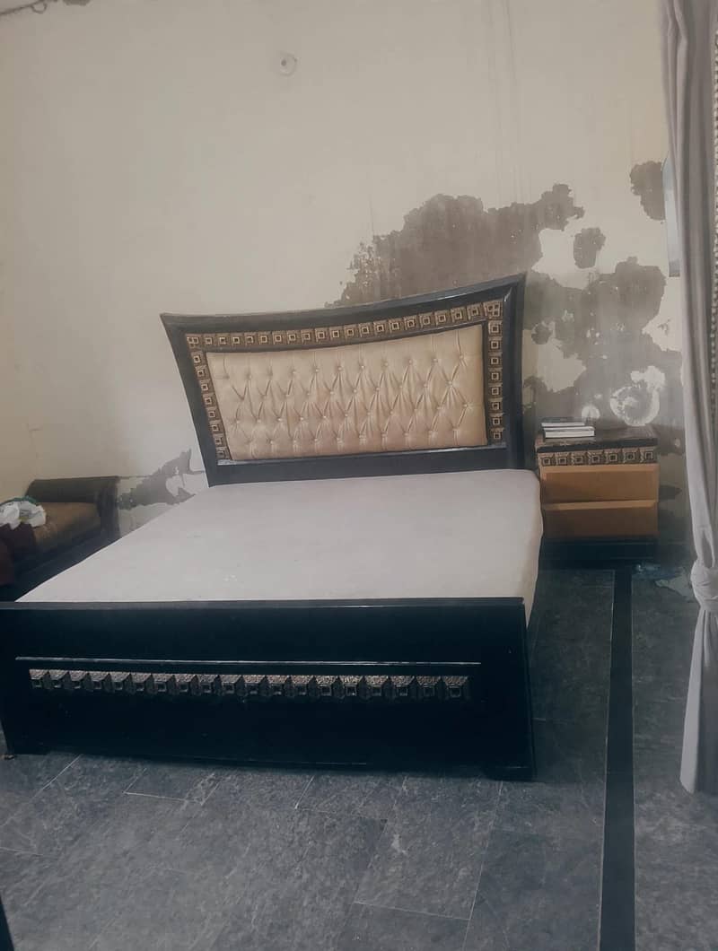 king size bed with devan and a side table 0