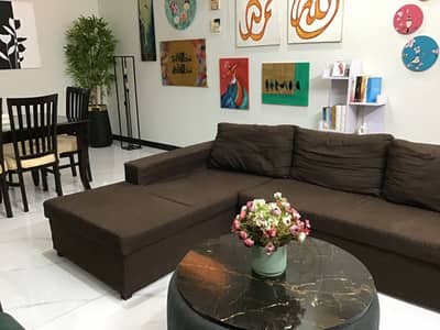 Brown l shaped sofa used