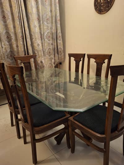 Glass Dining Table with wooden legs and wooden chairs