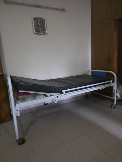 Medical bed with mattress and side railings.