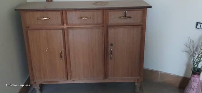 three drawers three doors with shelves