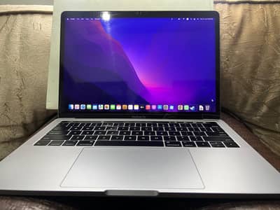 macbook pro with its original charger and box